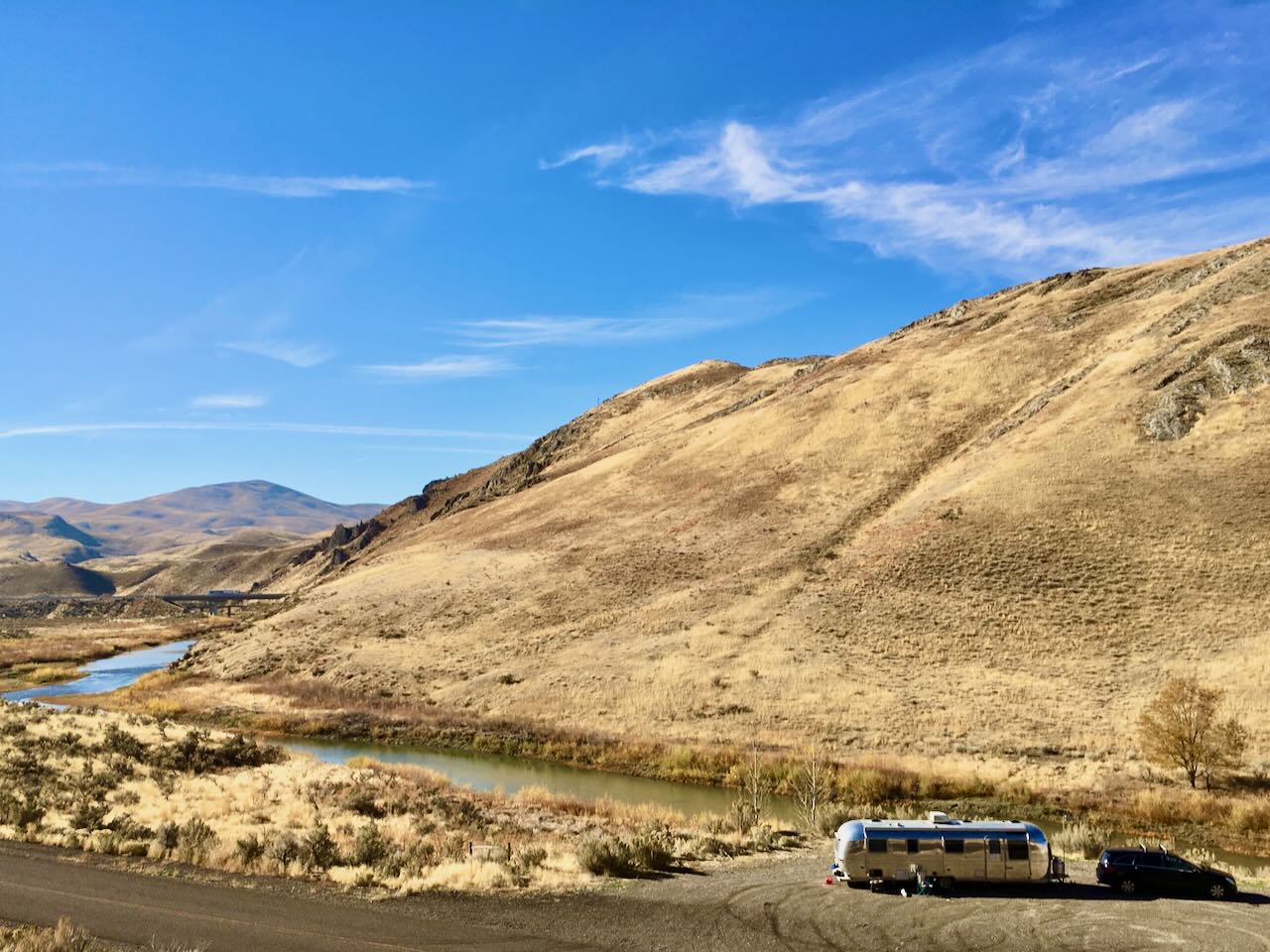 Golden hills with the rig tucked into the valley