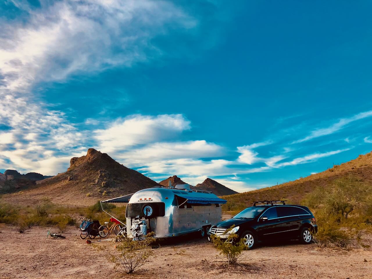 Camp set up under a brilliant desert sky, bikes at the ready